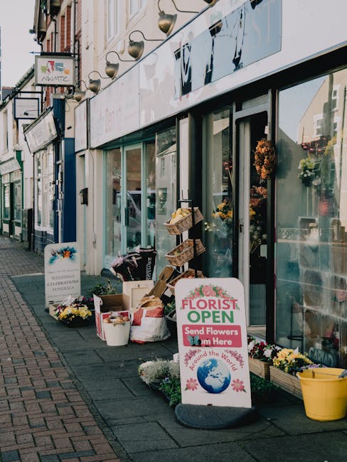 Exterior view of Sidcup Florist on High Street, displaying an arrangement of fresh flowers outside the shop. The display includes colorful bouquets with various flowers, such as chrysanthemums and dai